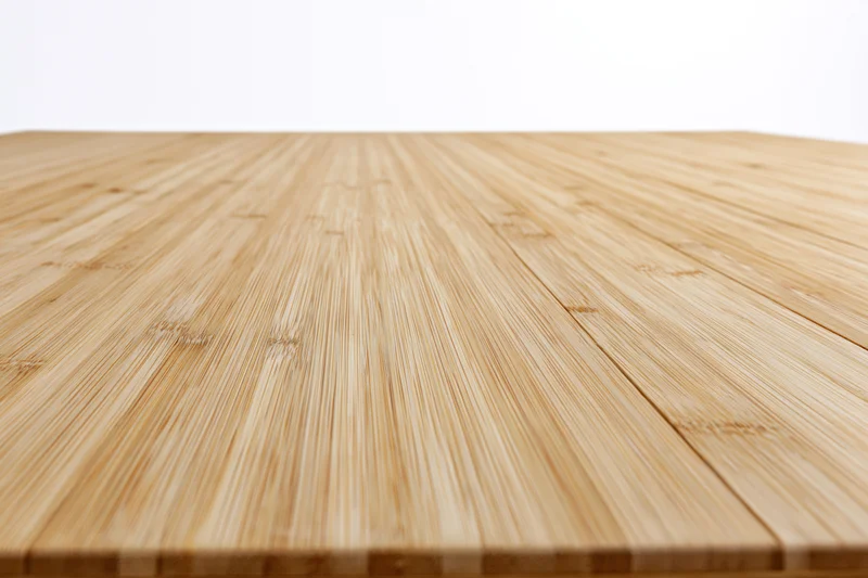Light bamboo wood plank floor receding into perspective with horizontal grain pattern and natural texture