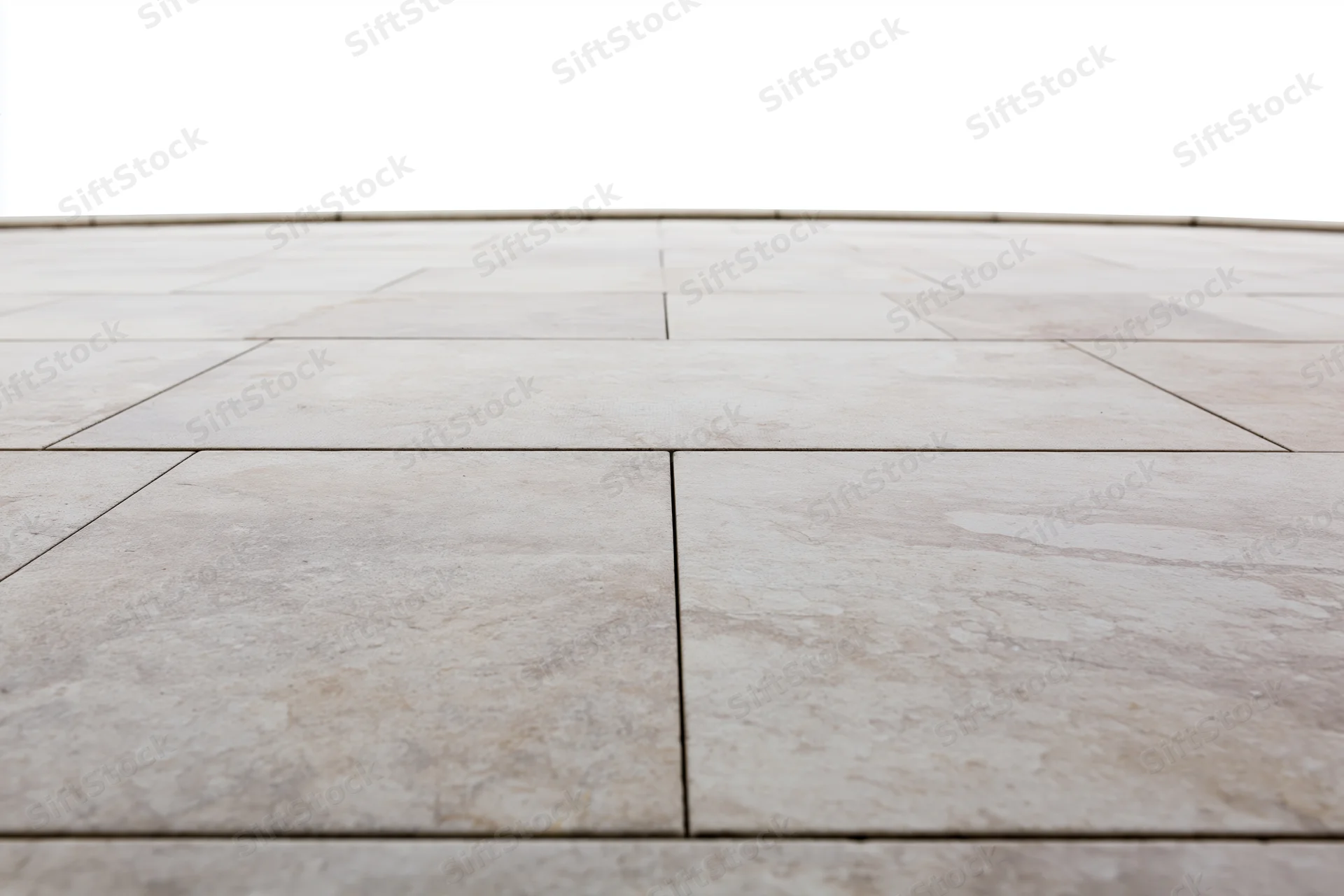 Light grey stone tile floor receding in perspective with visible grout lines and natural texture