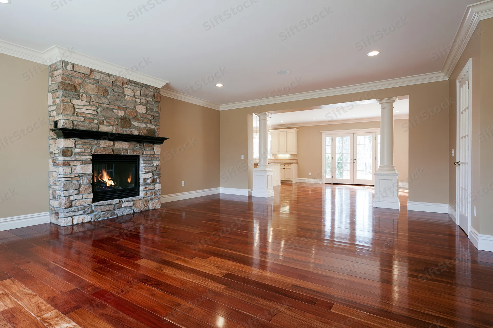 Empty luxury living room with dark cherry hardwood floor and stone fireplace