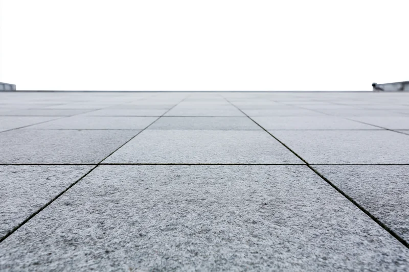 Stone tile plaza floor receding into the distance outdoors