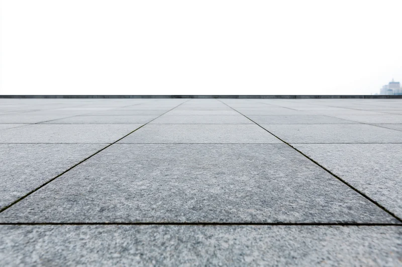 Stone tile pavement receding into the distance in an outdoor plaza