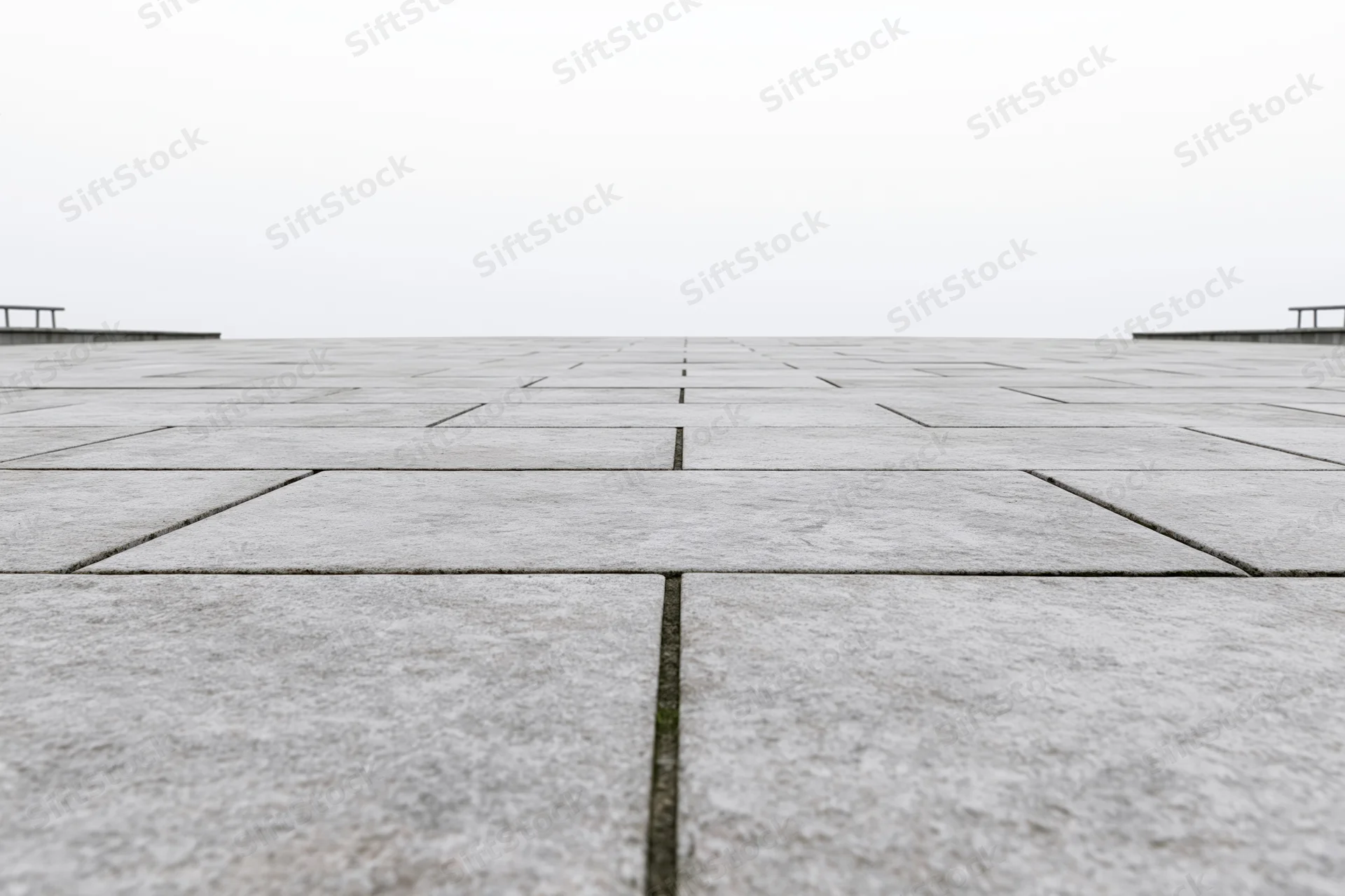 Stone tile plaza floor stretching to the horizon in an outdoor public space