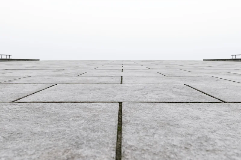 Stone tile plaza floor stretching to the horizon in an outdoor public space