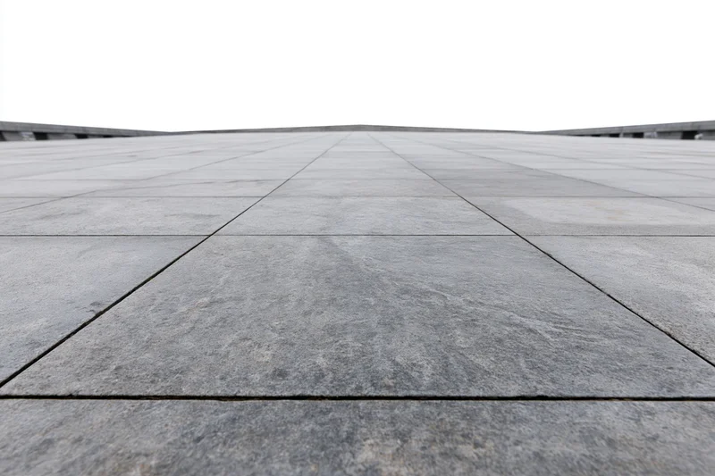Large grey concrete paving stones arranged in a grid across an empty public plaza