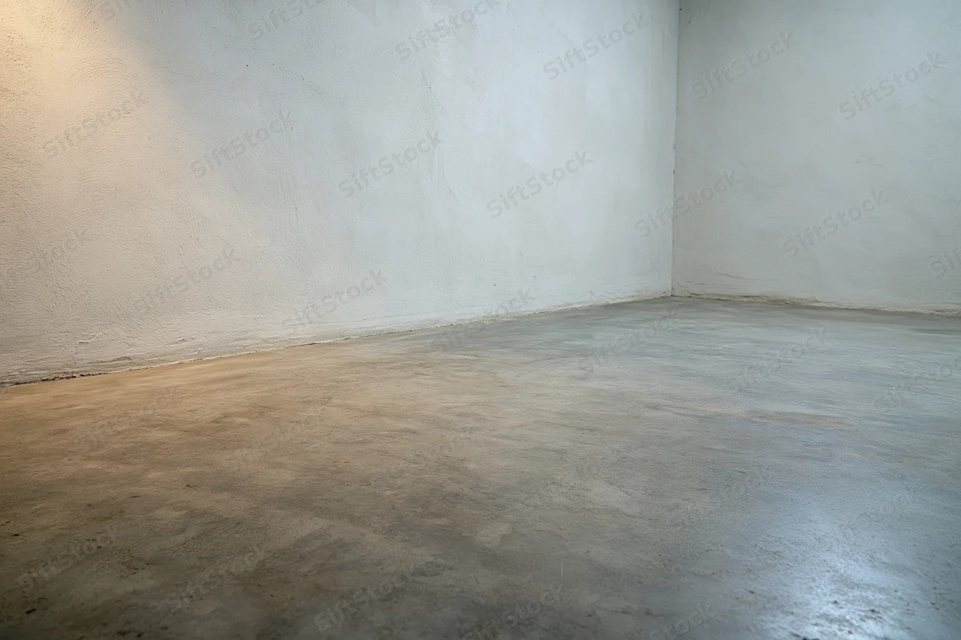 Empty room with bare concrete walls and smooth polished floor