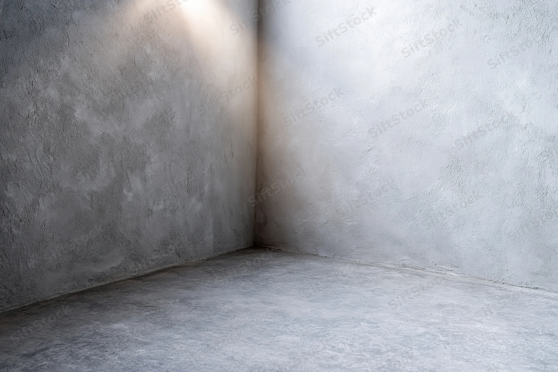 Empty concrete corner with textured walls and floor in a studio backdrop setting