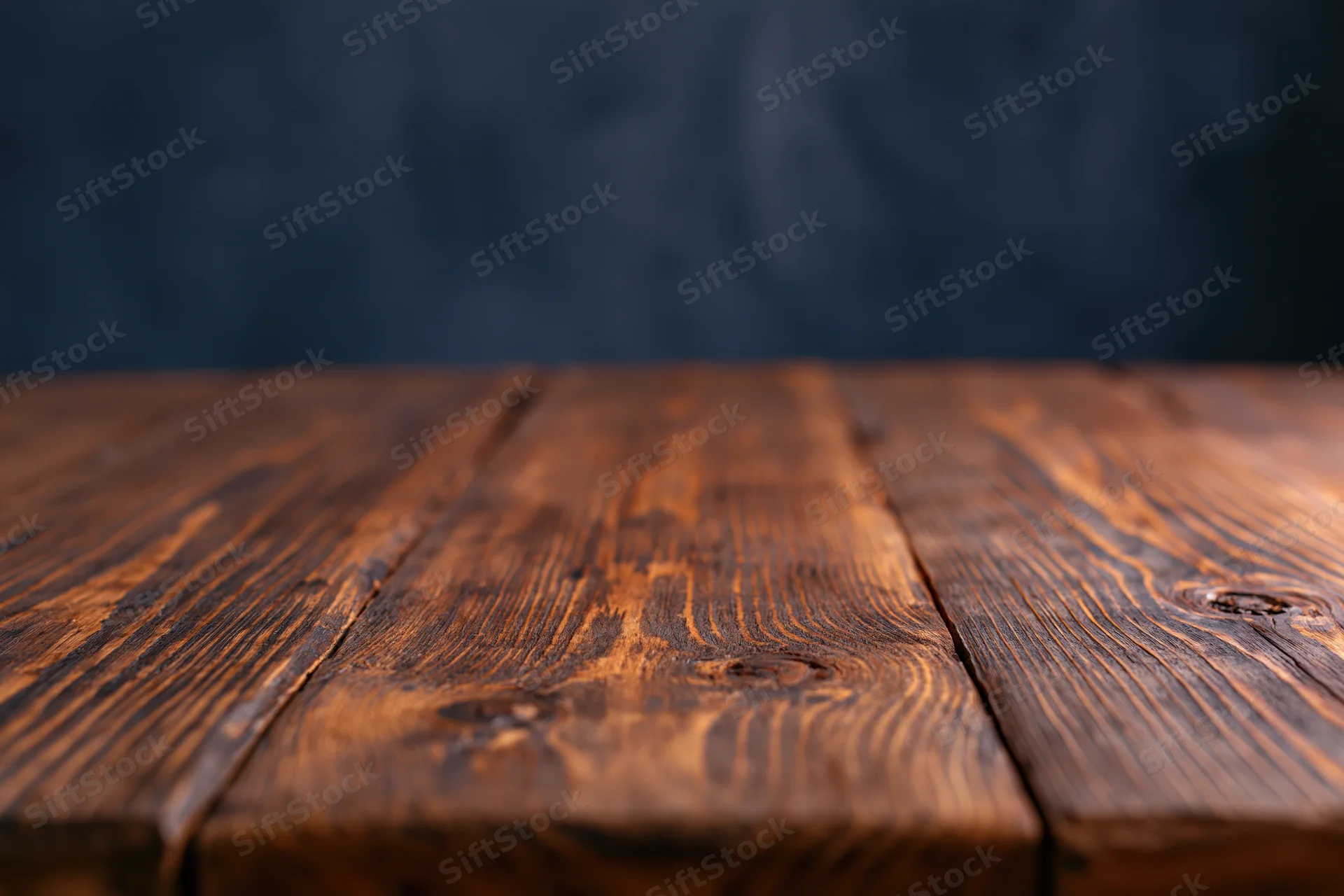 Empty wooden plank tabletop viewed from eye level with dark background