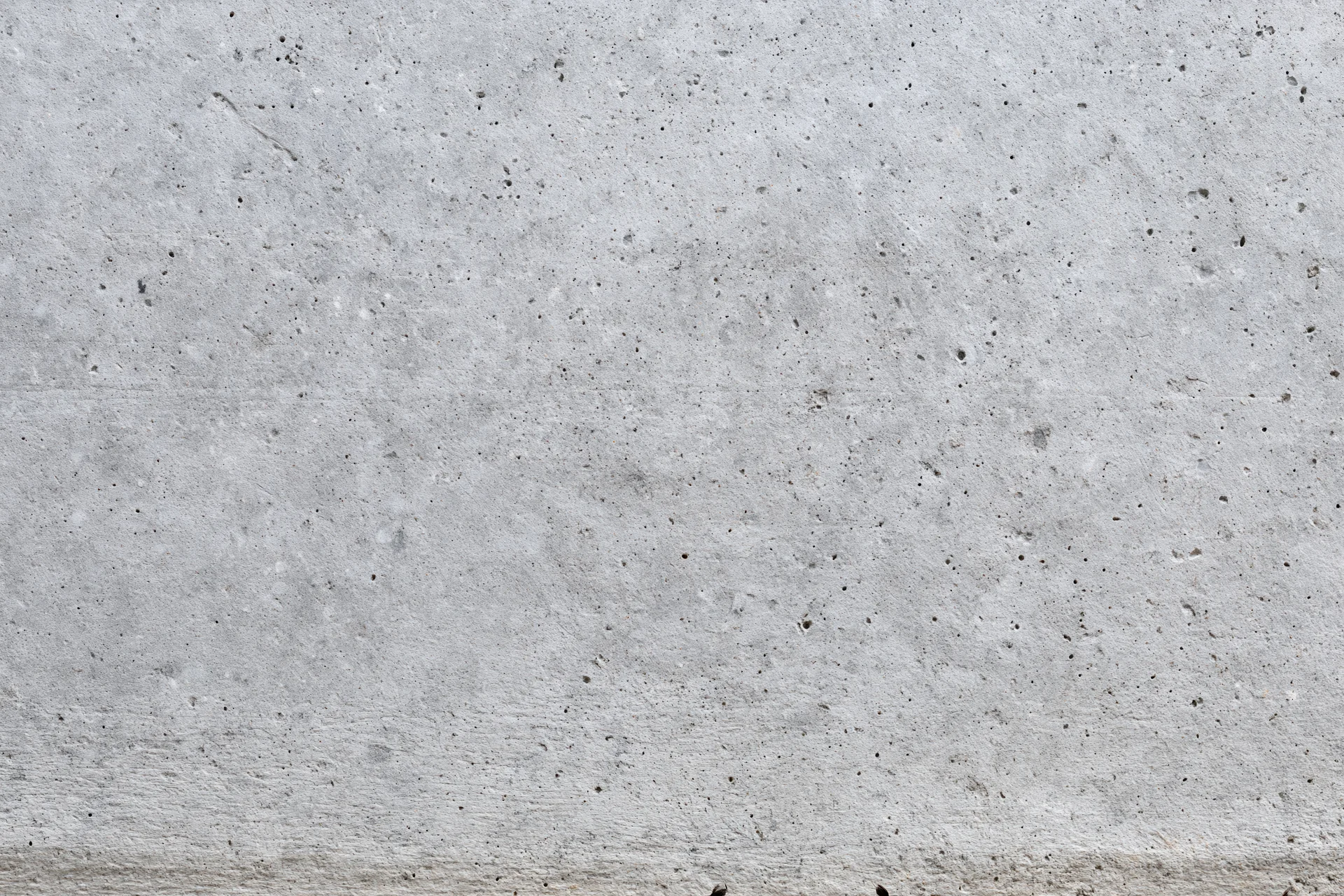 Flat concrete wall surface filling the frame with rough texture and gray tone