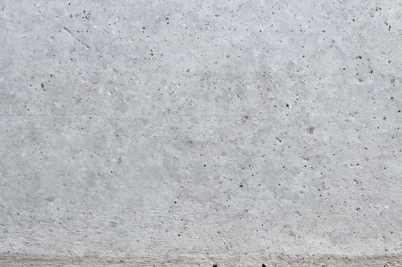 Flat concrete wall surface filling the frame with rough texture and gray tone