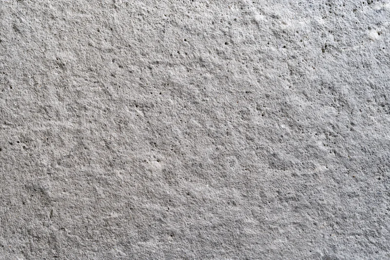 Flat concrete wall surface filling the frame with rough texture and gray tone