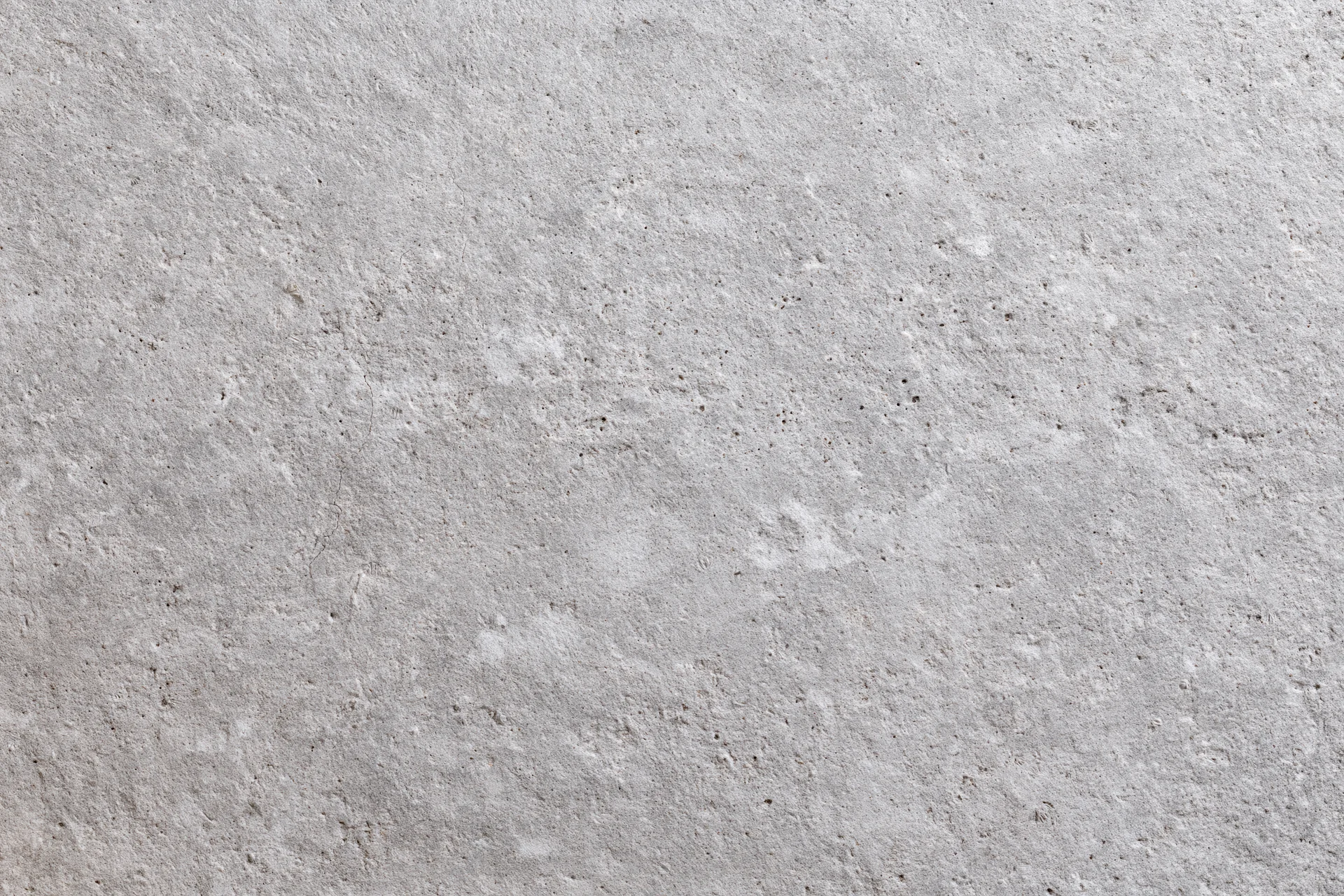 Flat concrete wall surface filling the frame with rough texture and gray tone
