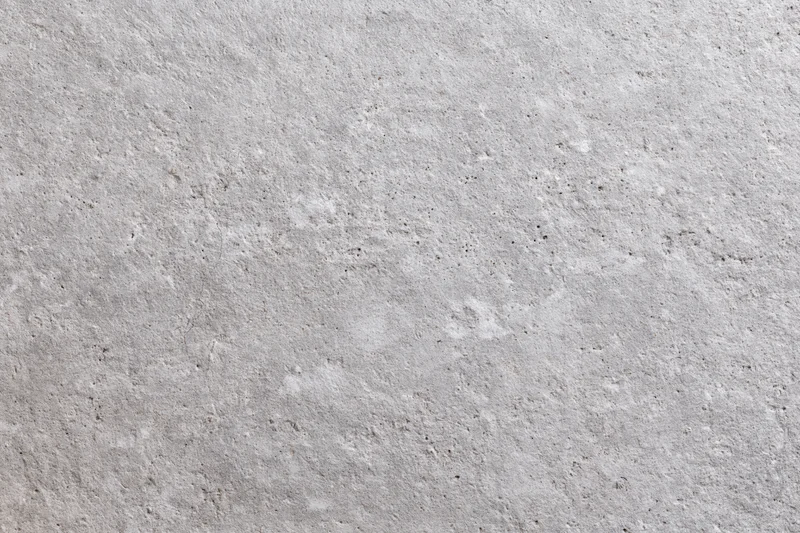 Flat concrete wall surface filling the frame with rough texture and gray tone