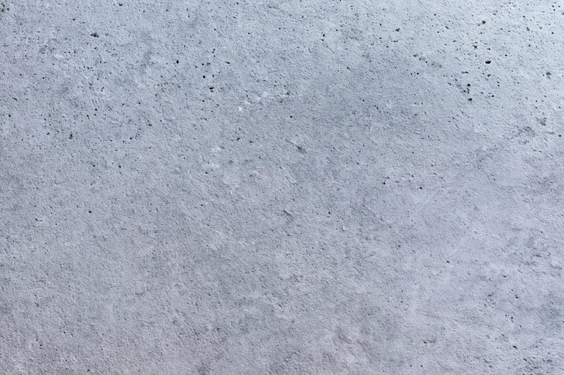 Flat concrete wall surface filling the frame with rough texture and gray tone