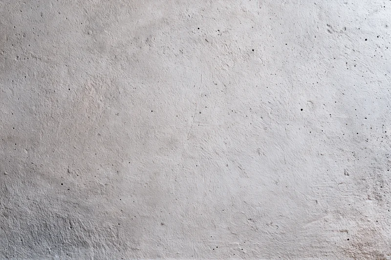 Flat concrete wall surface filling the frame with rough texture and gray tone