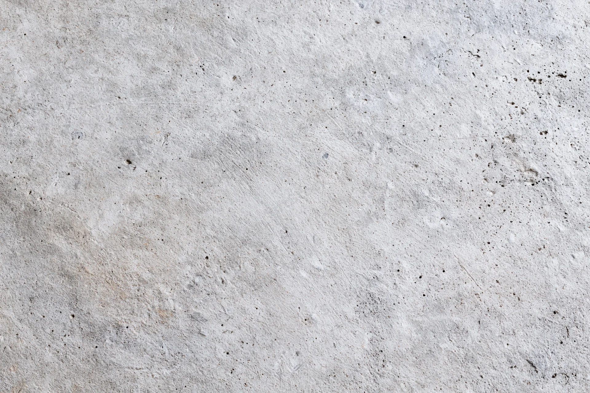 Flat concrete wall surface filling the frame with rough texture and gray tone