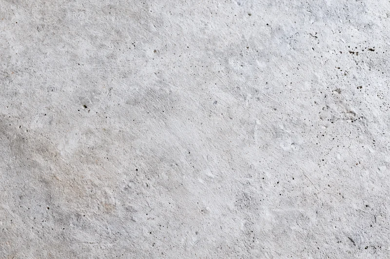 Flat concrete wall surface filling the frame with rough texture and gray tone