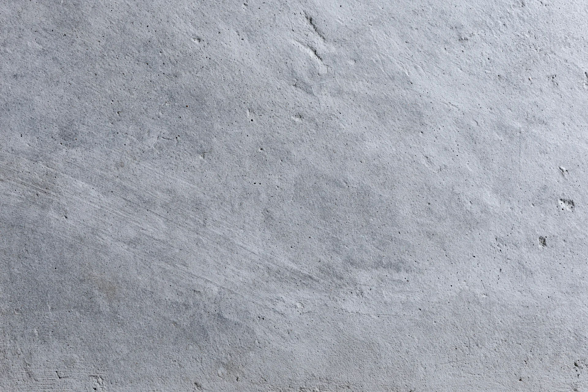 Flat concrete wall surface filling the frame with rough texture and gray tone