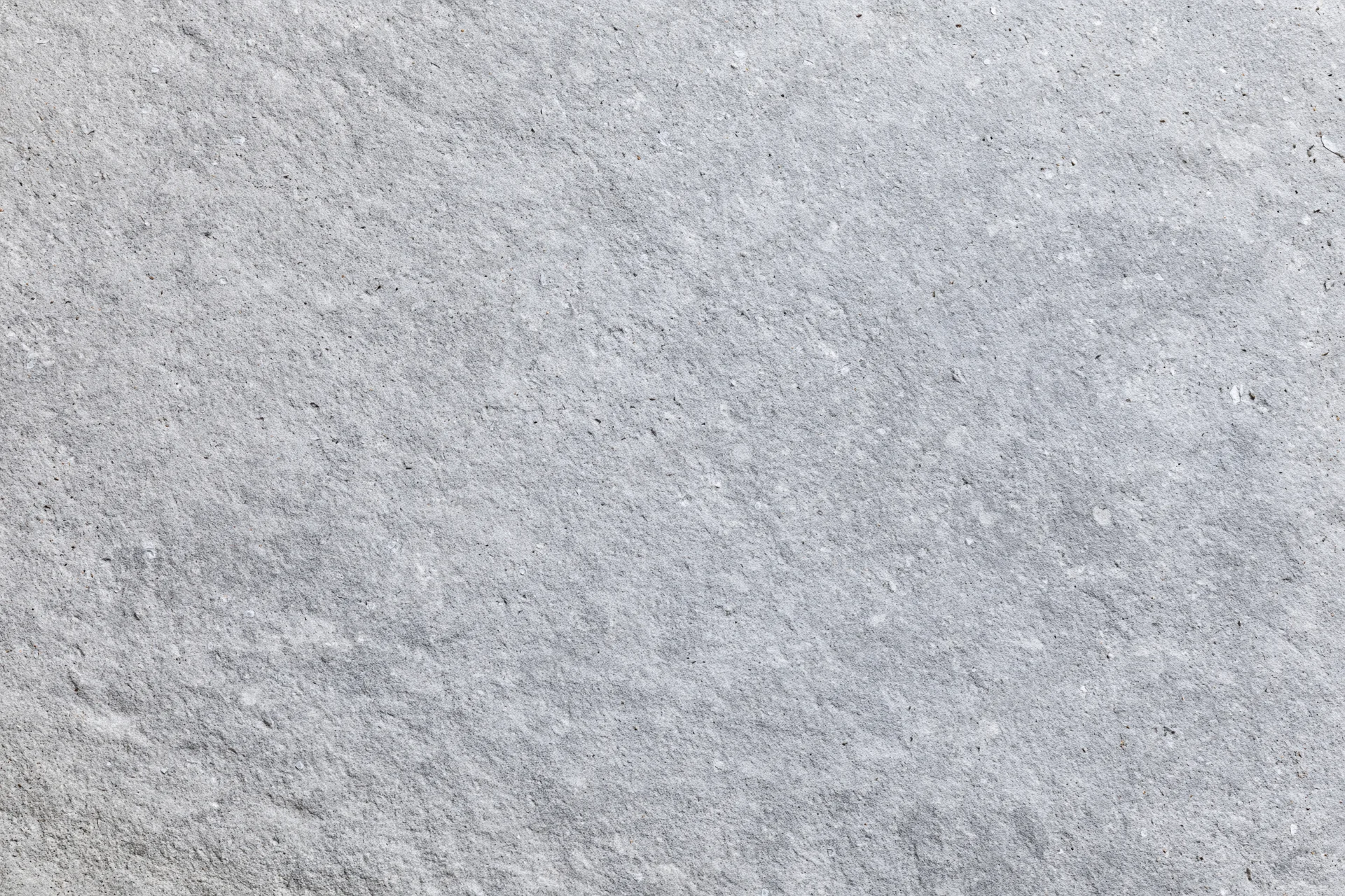 Flat concrete surface filling the frame with rough texture and gray tone