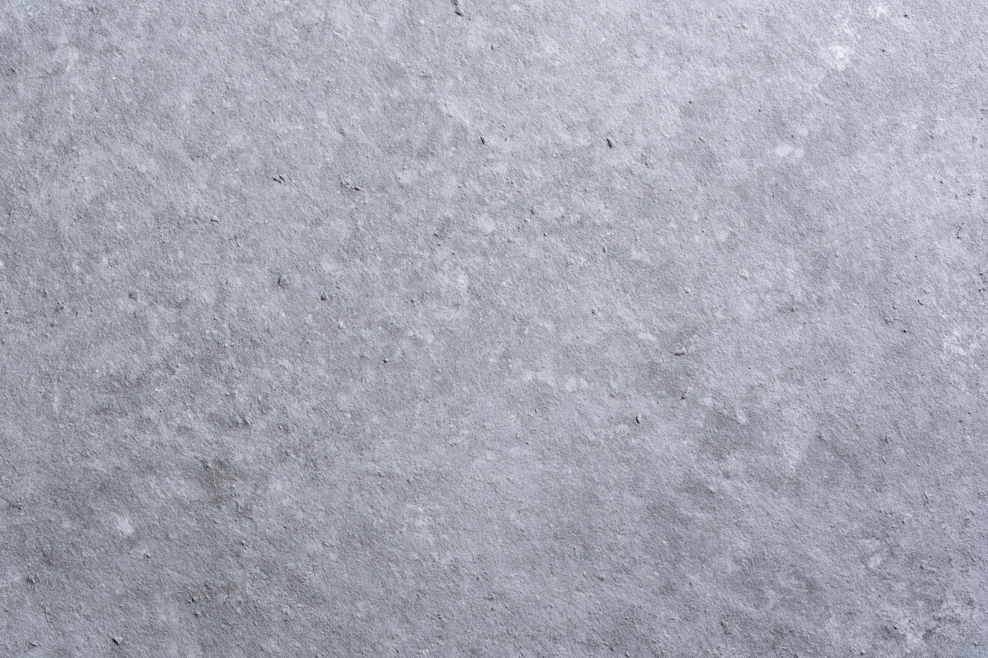 Flat concrete surface filling the frame with even gray texture