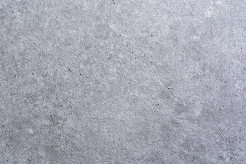 Flat concrete surface filling the frame with even gray texture