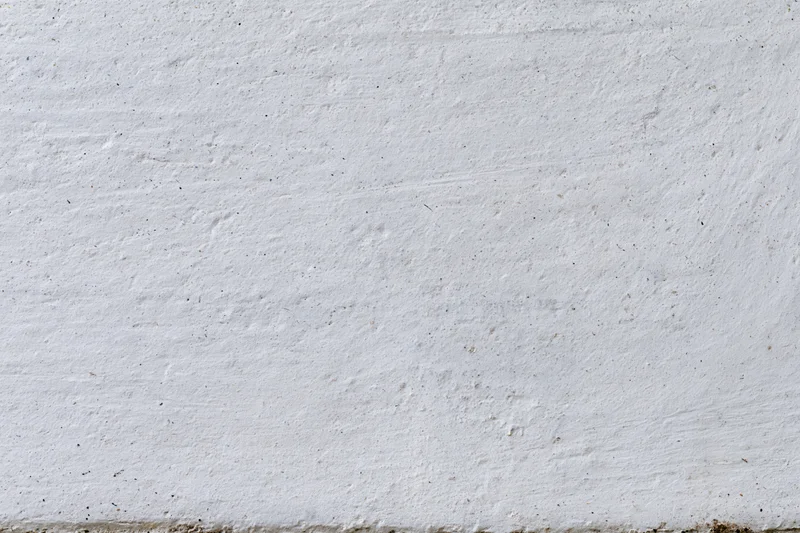 Flat concrete wall surface filling the entire frame with rough texture and neutral gray tone