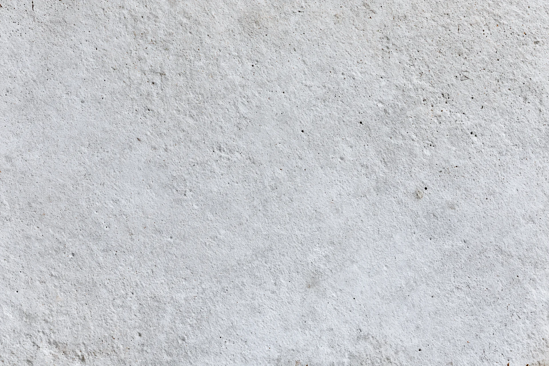 Flat concrete wall surface filling the frame with rough texture and gray tone