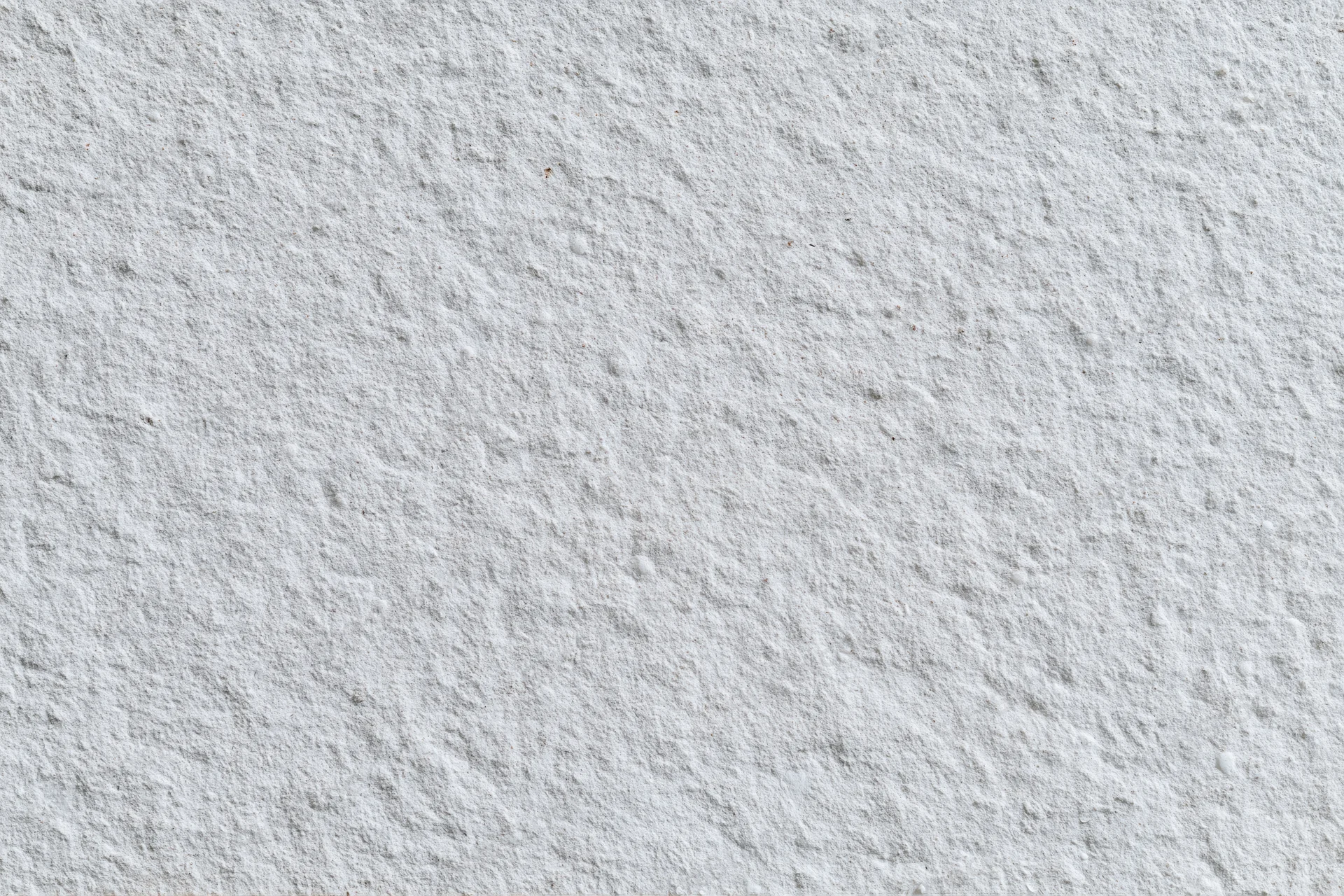 Flat concrete wall surface filling the frame with rough texture and neutral gray tone