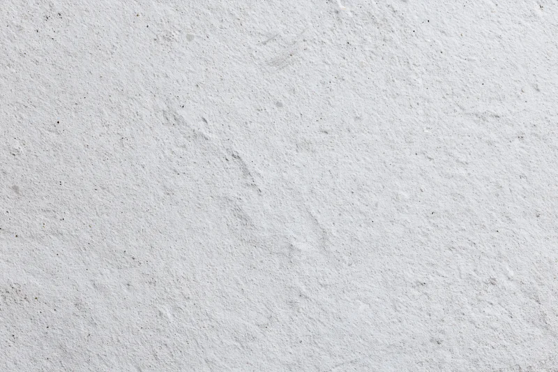Flat concrete wall surface filling the frame with rough texture and neutral gray tone