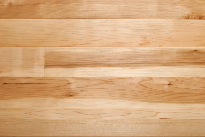 Horizontal maple hardwood floor surface with natural wood grain and warm tone