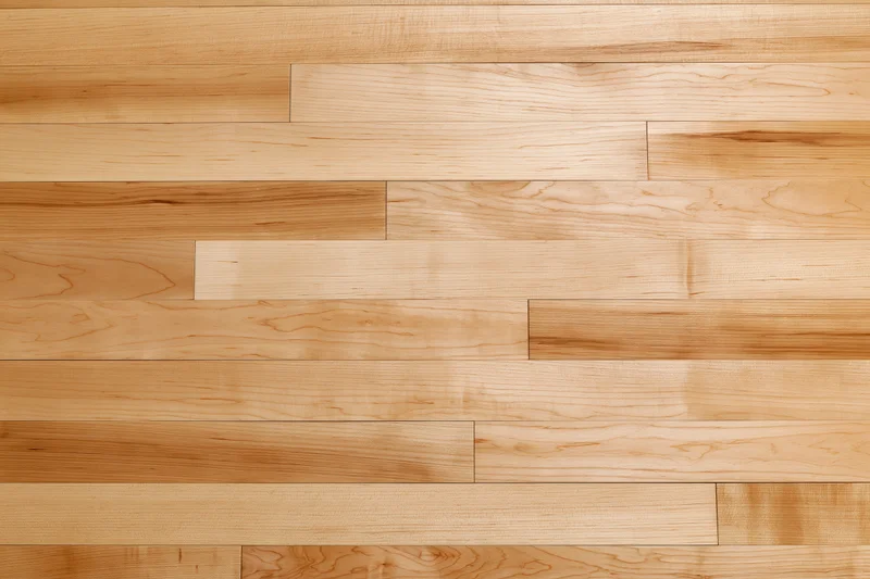 Horizontal maple hardwood floor planks arranged in staggered pattern for interior flooring