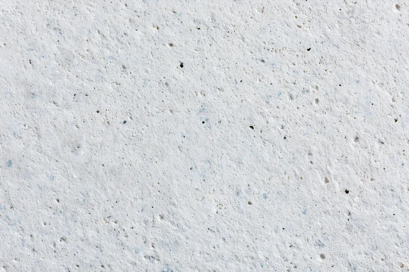 Close-up of a smooth concrete or limestone surface with natural texture and speckles