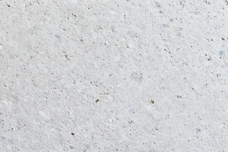Close-up of a smooth concrete or limestone surface with natural texture and speckles