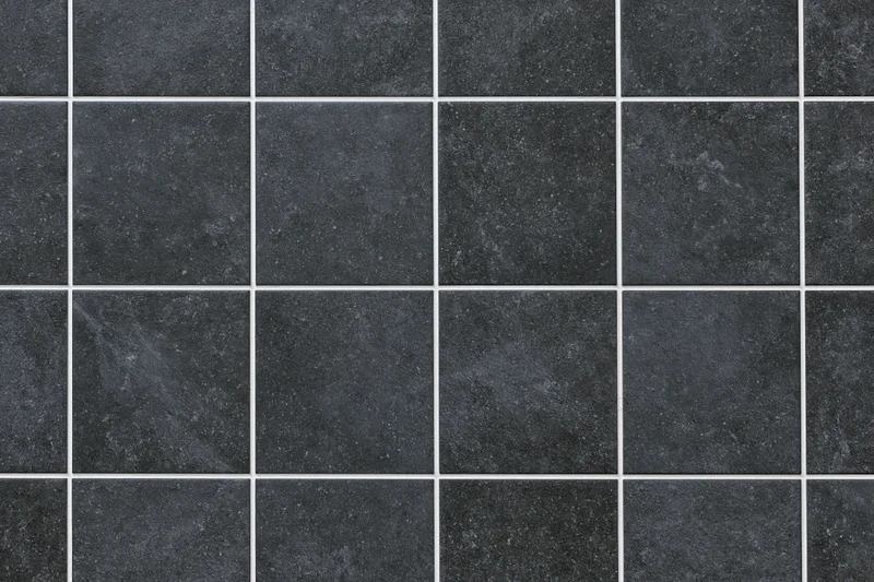 Dark charcoal ceramic floor tiles arranged in a grid pattern with white grout