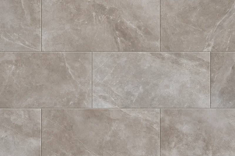 Large-format stone-look ceramic floor tiles arranged in a staggered pattern for interior flooring