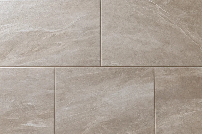 Large-format stone-look ceramic floor tiles arranged in a grid pattern for interior flooring