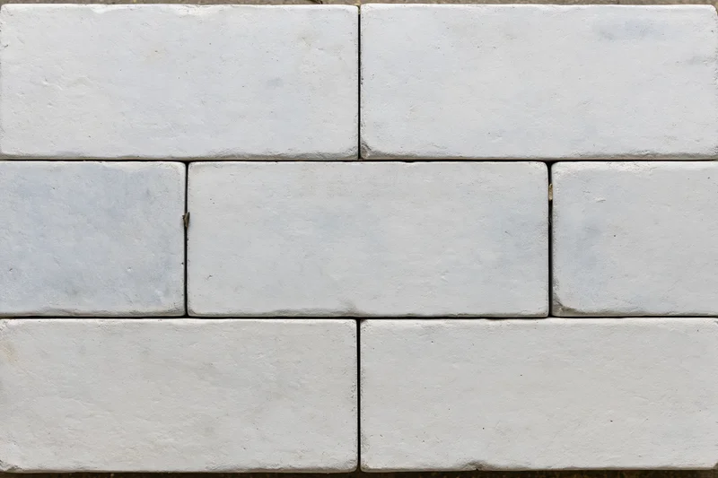Light grey concrete paving slabs arranged in a grid pattern for outdoor flooring