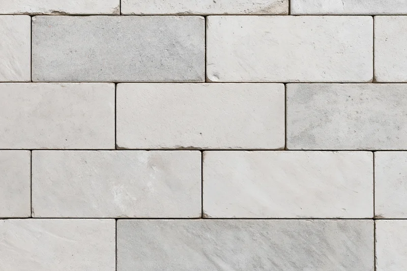 Light grey concrete paving slabs arranged in a grid pattern for outdoor flooring