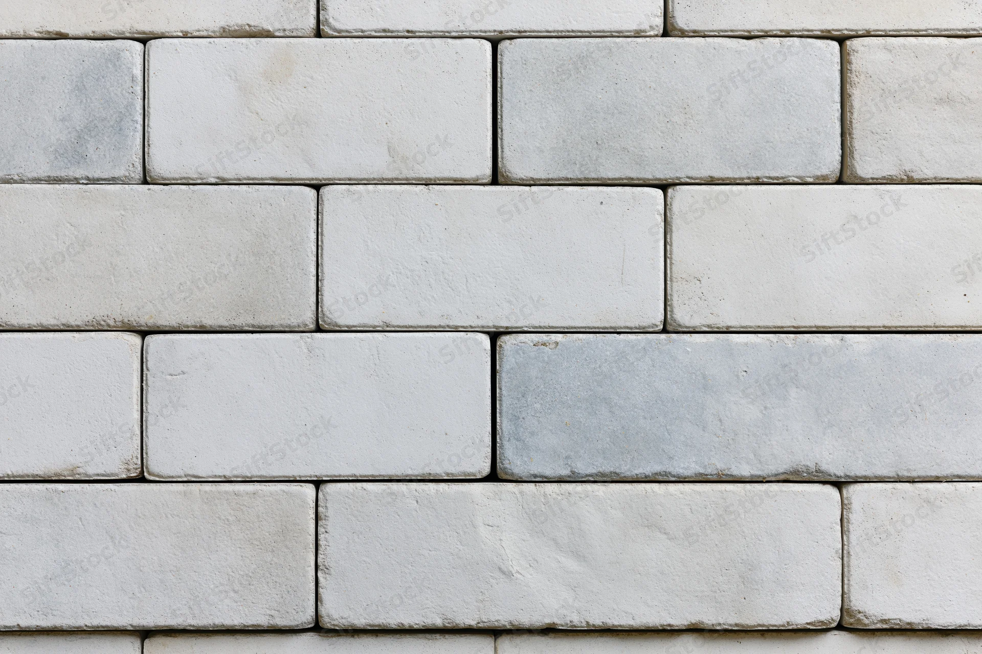Light grey concrete paving slabs arranged in a grid pattern for outdoor flooring