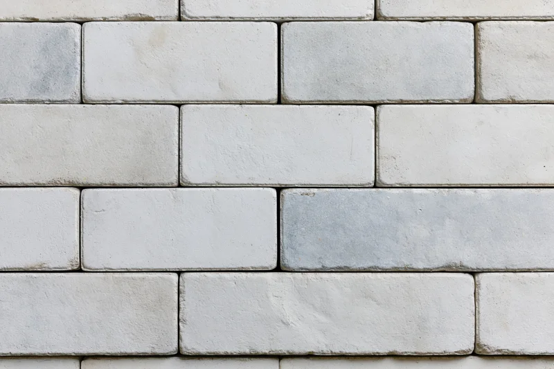 Light grey concrete paving slabs arranged in a grid pattern for outdoor flooring