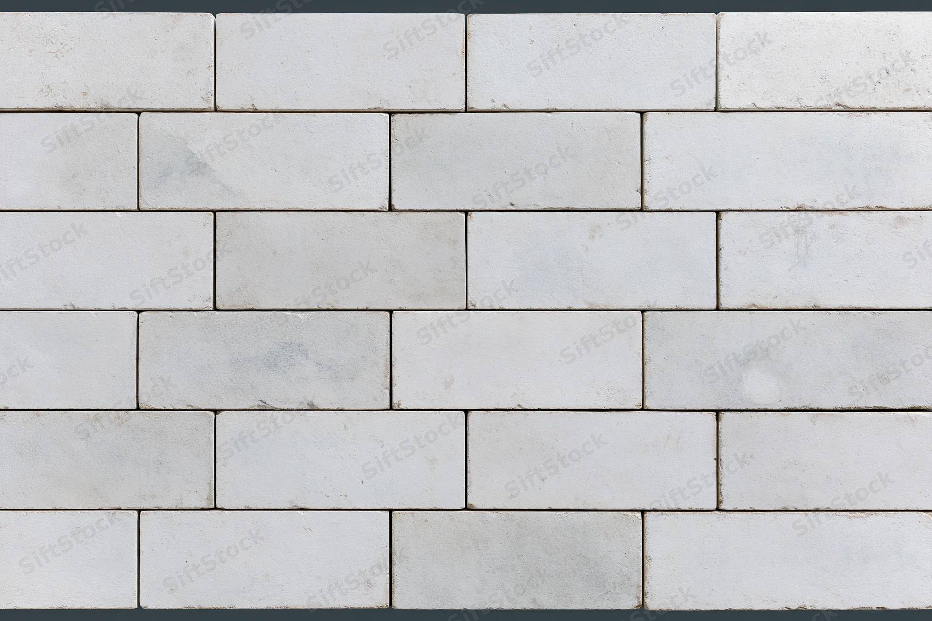 Light grey concrete paving slabs arranged in a staggered pattern for outdoor flooring