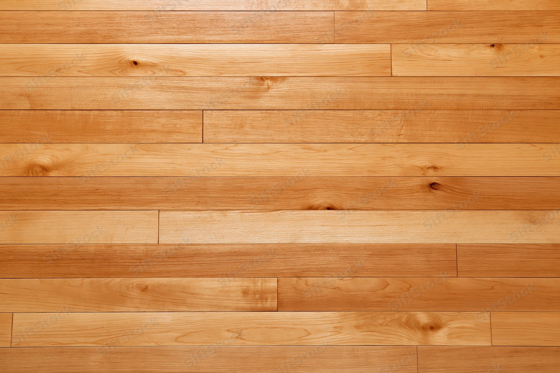 Horizontal hardwood strip flooring with natural wood grain and warm tone covering the floor surface