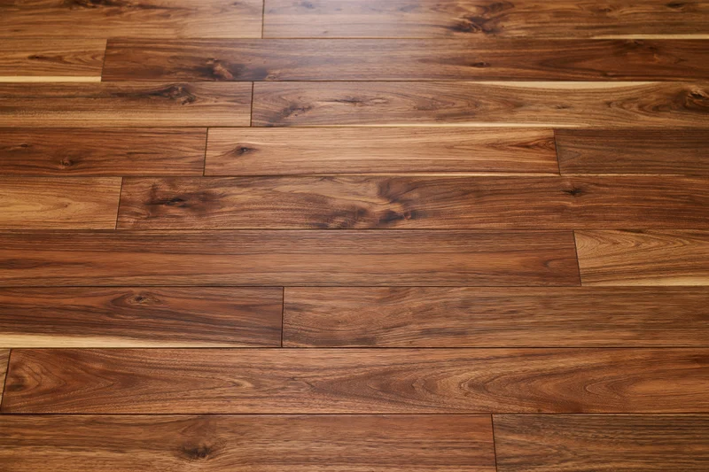 Medium-brown hardwood parquet floor arranged in staggered planks for interior flooring