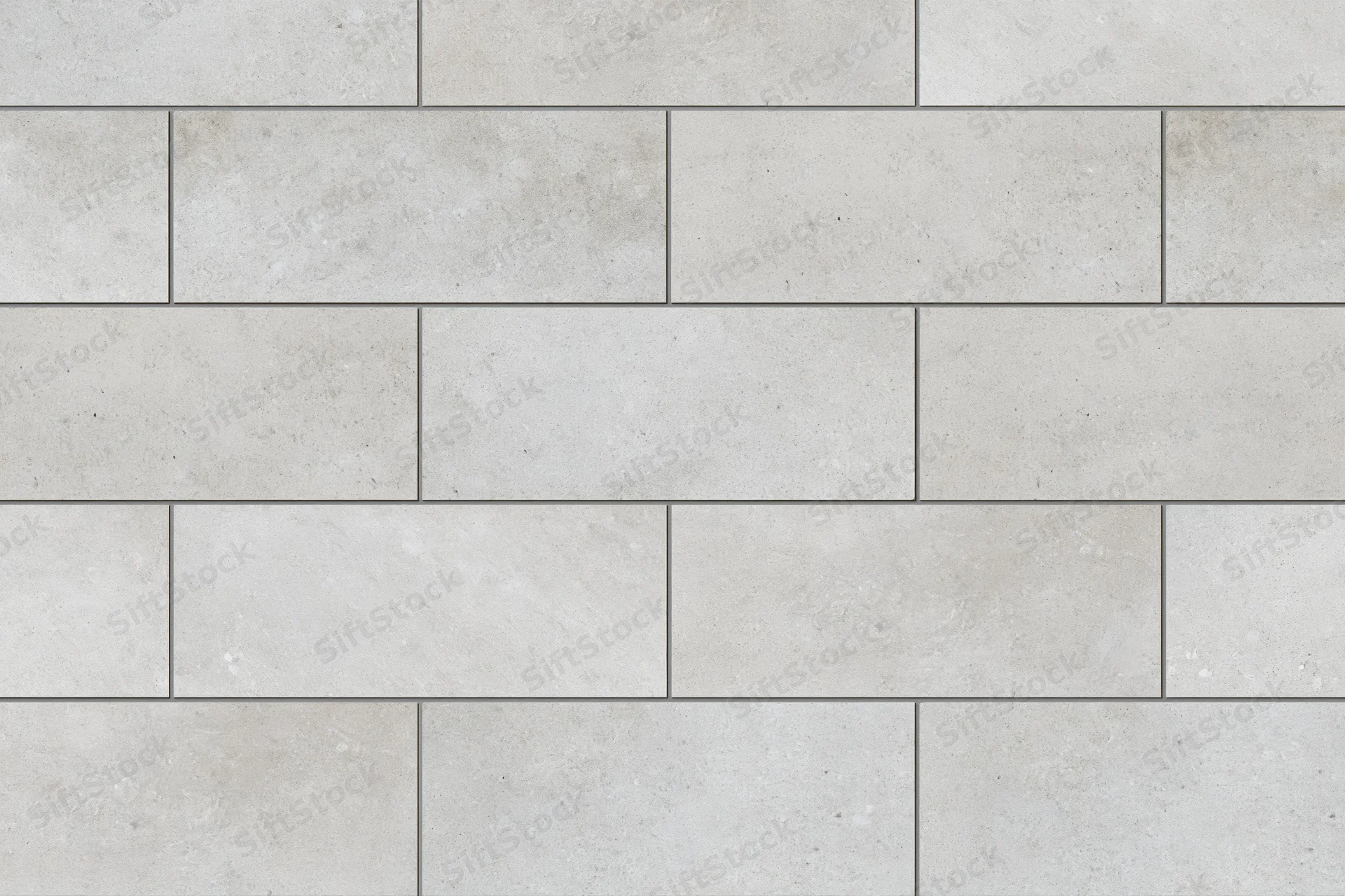 Large-format concrete-look ceramic tiles arranged in a staggered pattern on a wall or floor surface