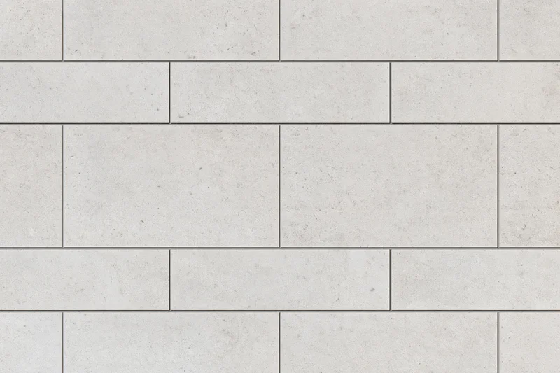 Large-format concrete-look ceramic tiles arranged in a staggered grid pattern for interior flooring or wall cladding
