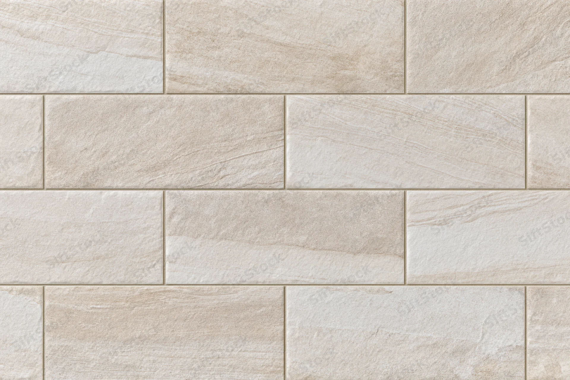Large-format stone-look ceramic floor tiles arranged in a staggered pattern for interior flooring