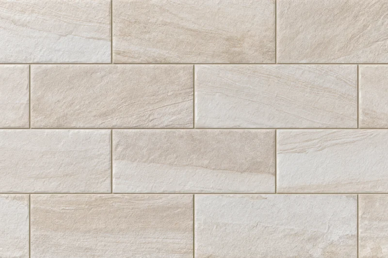 Large-format stone-look ceramic floor tiles arranged in a staggered pattern for interior flooring