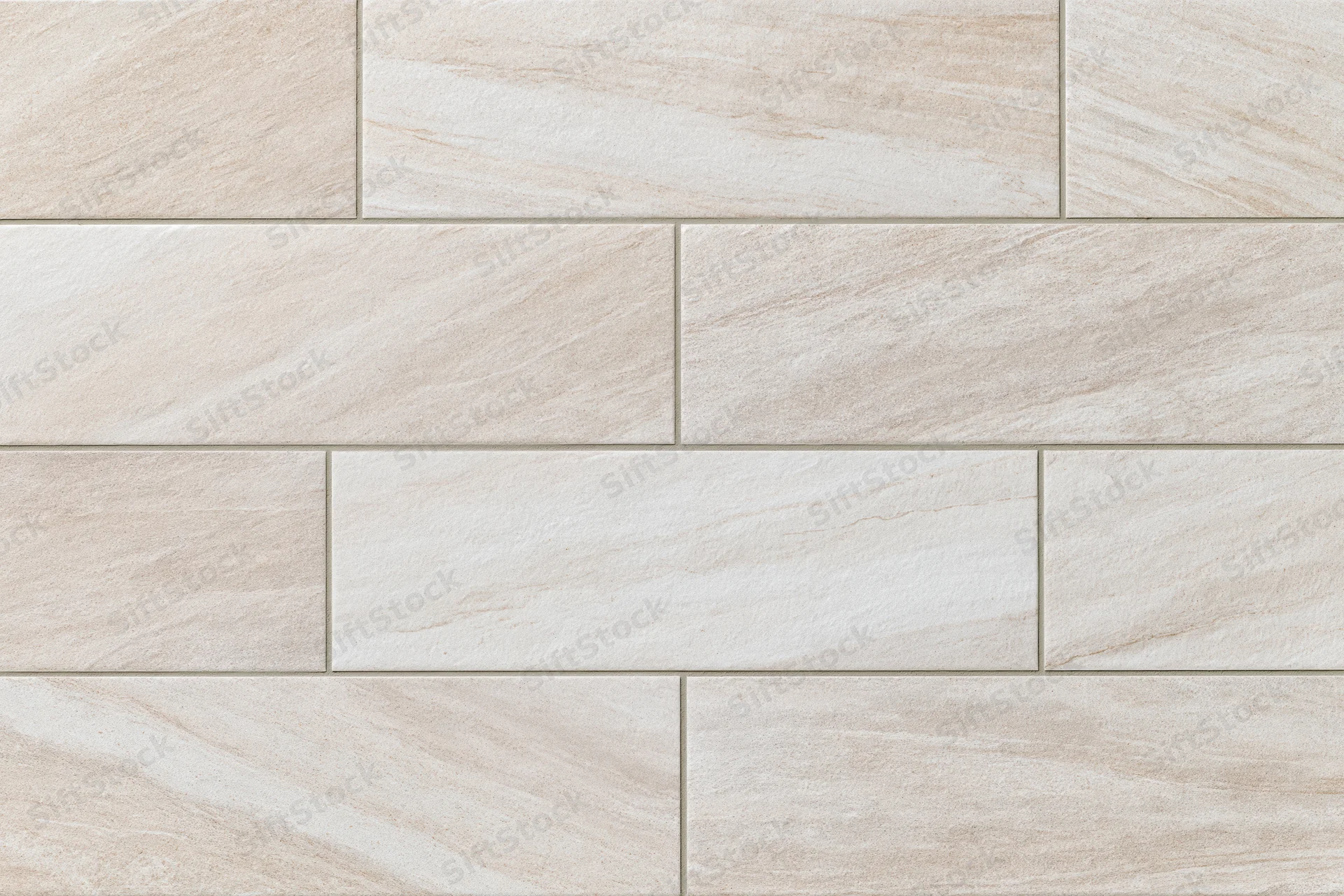 Large-format stone-look ceramic floor tiles arranged in a staggered pattern for interior flooring