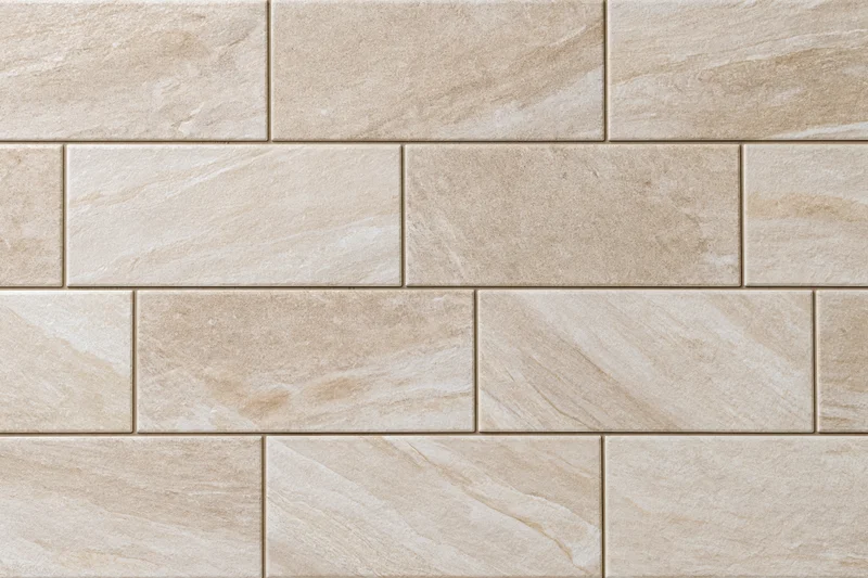 Large-format stone-look ceramic floor tiles arranged in a staggered brick pattern for interior flooring