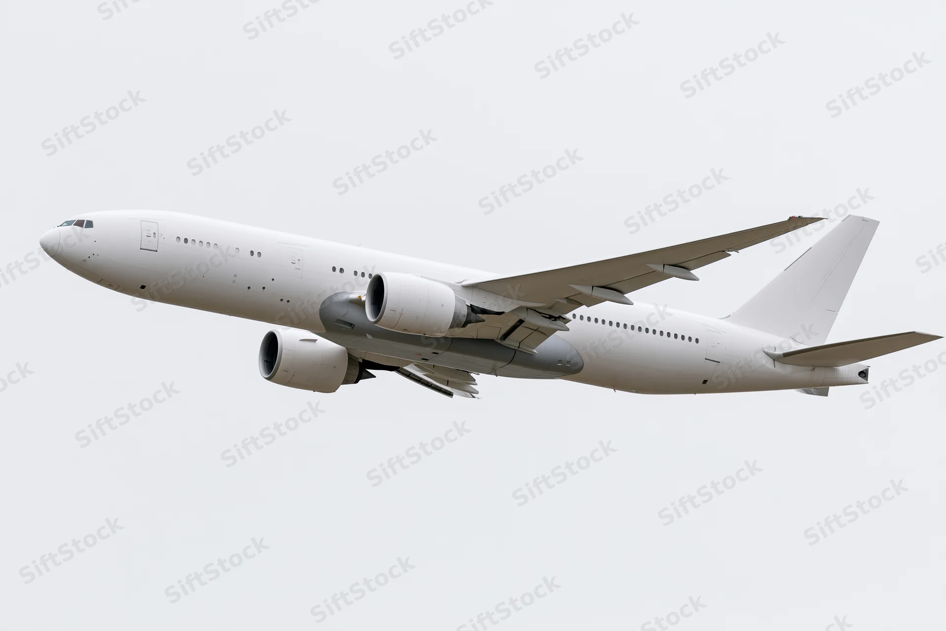 White wide-body commercial passenger jet in level flight against overcast sky