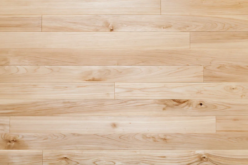 Light blonde hardwood floor planks laid horizontally filling the frame